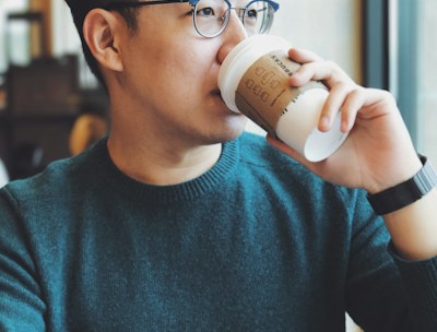 man holding Starbucks disposable cup
